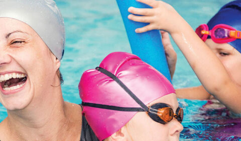 Mother and children in swimming pool